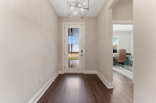 entryway with a chandelier, baseboards, and wood finished floors