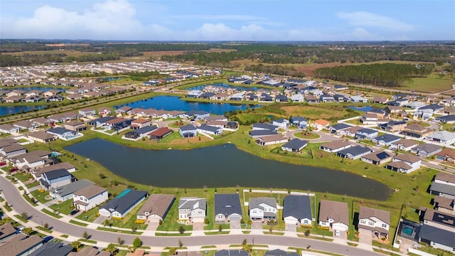 birds eye view of property featuring a water view and a residential view