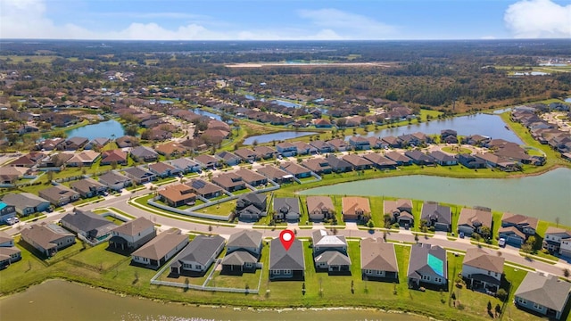 birds eye view of property featuring a water view and a residential view