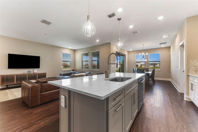 kitchen featuring visible vents, light countertops, a sink, and gray cabinetry