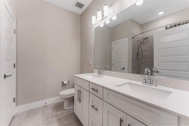 bathroom with toilet, baseboards, visible vents, and a sink