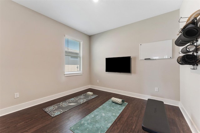 unfurnished living room featuring baseboards and wood finished floors