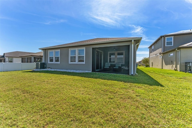 back of house with a sunroom, fence, cooling unit, a yard, and stucco siding