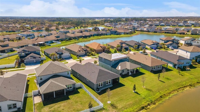 drone / aerial view with a water view and a residential view