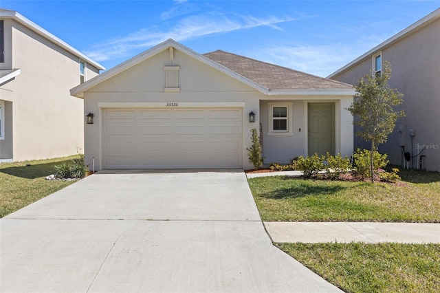 view of front of property featuring a garage, concrete driveway, roof with shingles, a front lawn, and stucco siding