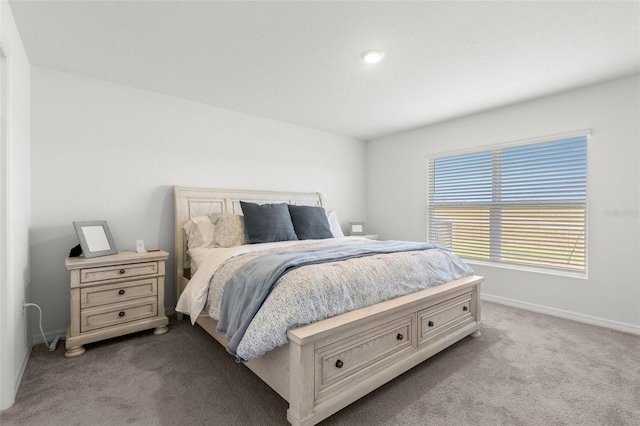 bedroom featuring carpet floors and baseboards