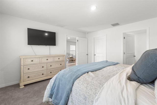 carpeted bedroom featuring visible vents and baseboards