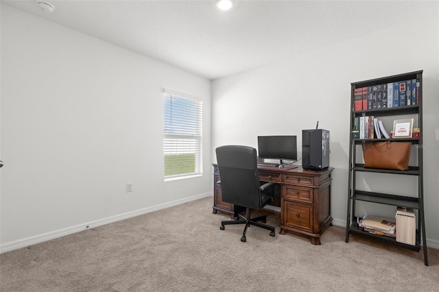 carpeted office featuring baseboards