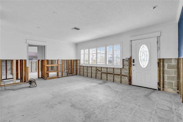 entrance foyer featuring visible vents and a textured ceiling