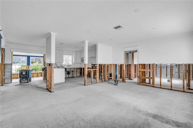 miscellaneous room featuring concrete flooring, visible vents, and a textured ceiling