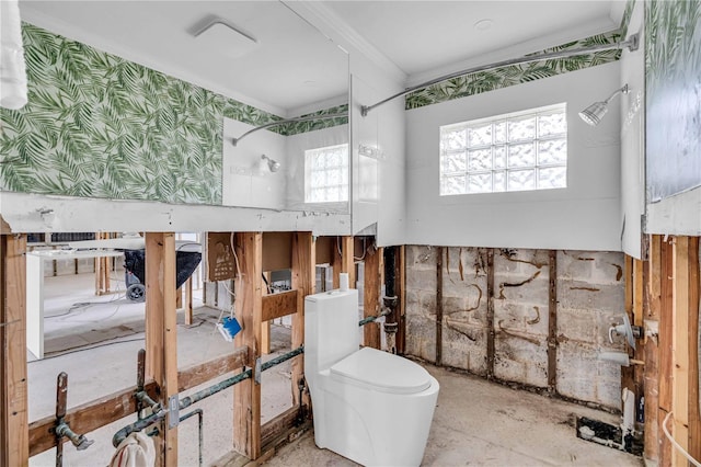 bathroom with crown molding, toilet, and wallpapered walls