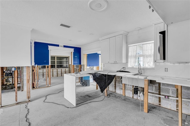 kitchen with visible vents and white cabinetry