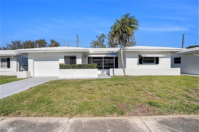 ranch-style home with an attached garage, a tiled roof, concrete driveway, stucco siding, and a front yard