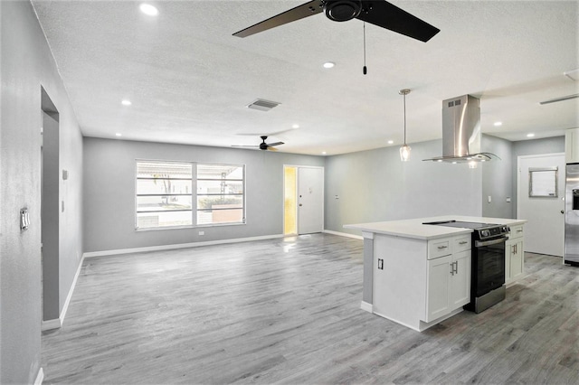 kitchen featuring visible vents, stainless steel fridge with ice dispenser, open floor plan, island exhaust hood, and range with electric stovetop