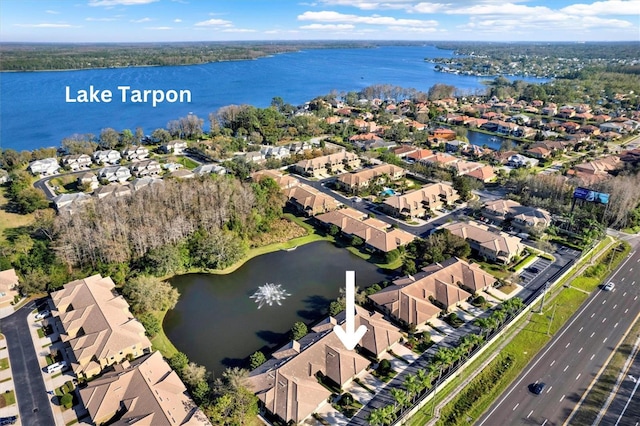 drone / aerial view featuring a water view and a residential view