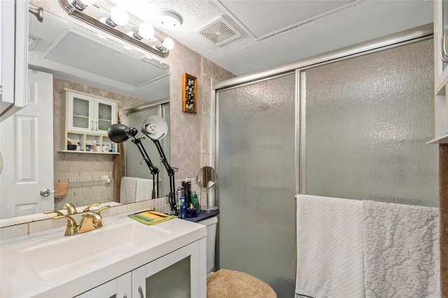 full bathroom with a stall shower, visible vents, backsplash, and vanity