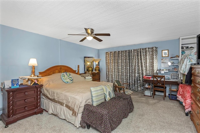 bedroom with carpet floors, a ceiling fan, and a textured ceiling