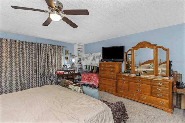 bedroom with ceiling fan, a textured ceiling, and carpet flooring