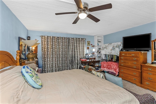 bedroom featuring a ceiling fan, a textured ceiling, and carpet flooring