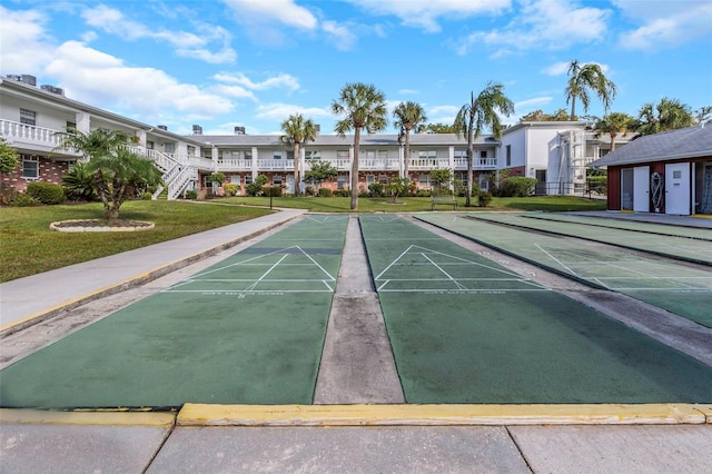 view of community with shuffleboard, a yard, and a residential view