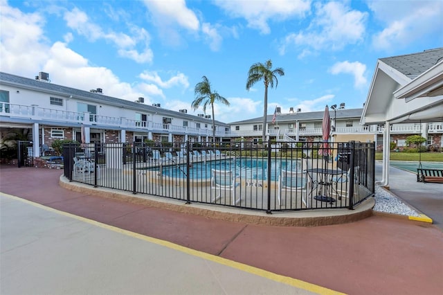 view of pool featuring fence