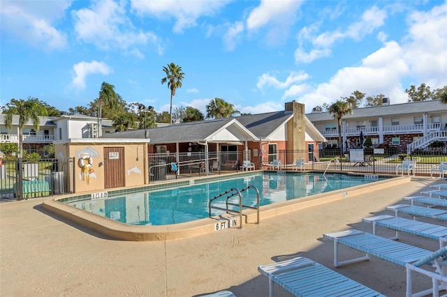 community pool featuring fence and a patio