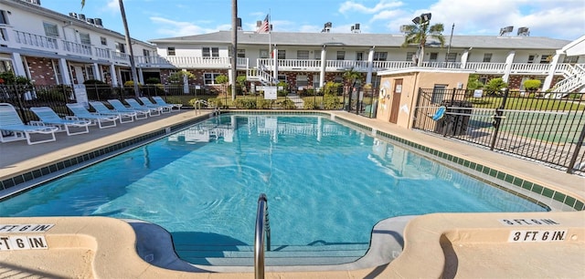 view of pool featuring fence