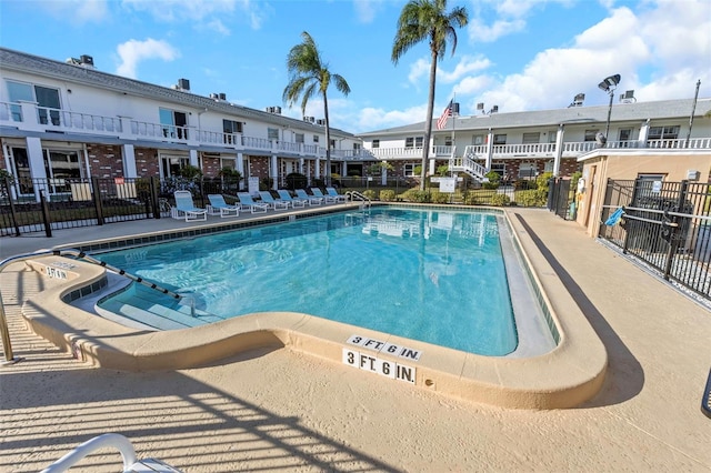 view of swimming pool with fence