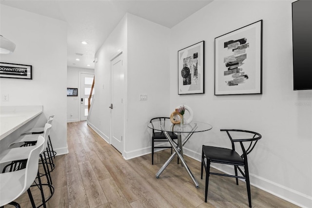 hallway with recessed lighting, baseboards, and wood finished floors