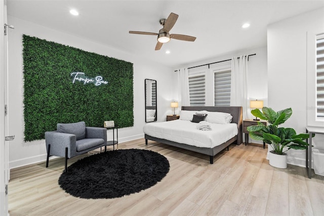 bedroom featuring baseboards, wood finished floors, a ceiling fan, and recessed lighting