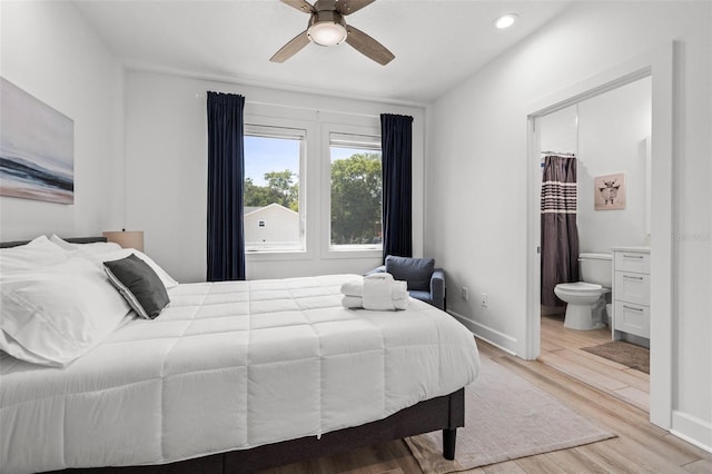 bedroom with light wood finished floors, recessed lighting, a ceiling fan, connected bathroom, and baseboards