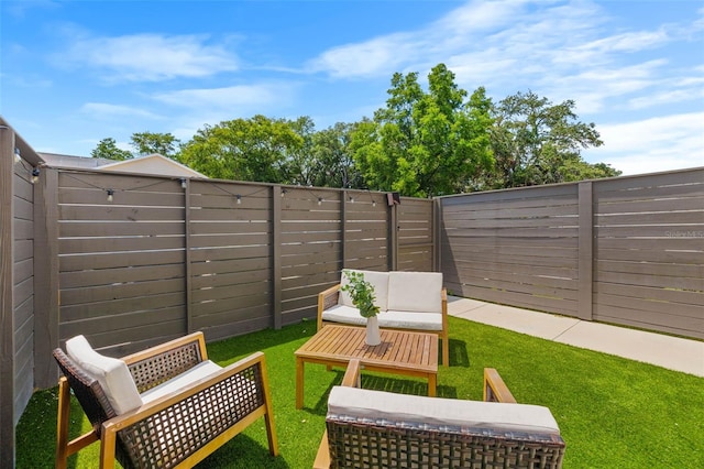 view of patio / terrace featuring a fenced backyard and an outdoor living space