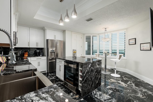 kitchen with beverage cooler, marble finish floor, stainless steel refrigerator with ice dispenser, and visible vents