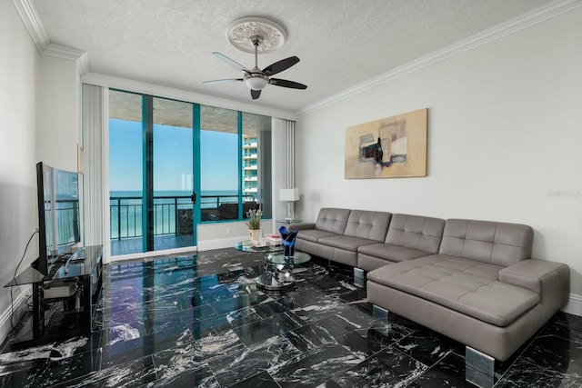 living area with ornamental molding, marble finish floor, ceiling fan, and baseboards