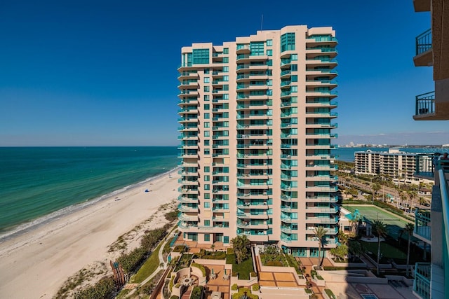 view of building exterior with a view of the beach and a water view