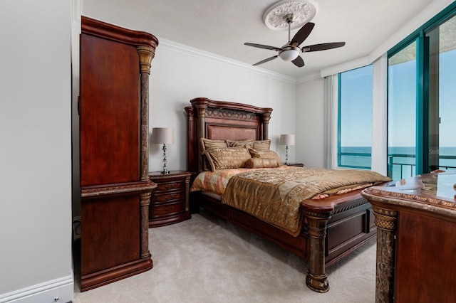 carpeted bedroom featuring ceiling fan, access to outside, ornamental molding, and multiple windows