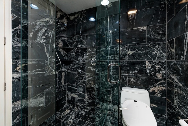 bathroom featuring a shower stall and toilet