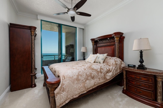 carpeted bedroom with access to exterior, ornamental molding, baseboards, and ceiling fan