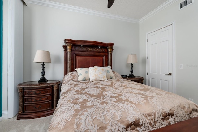 bedroom with a ceiling fan, carpet flooring, visible vents, and crown molding