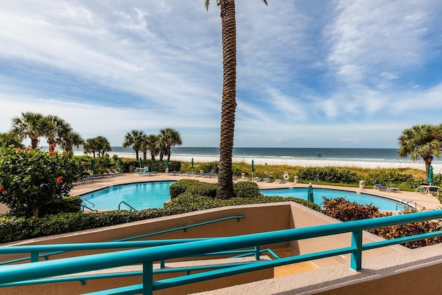 community pool featuring a water view and a patio