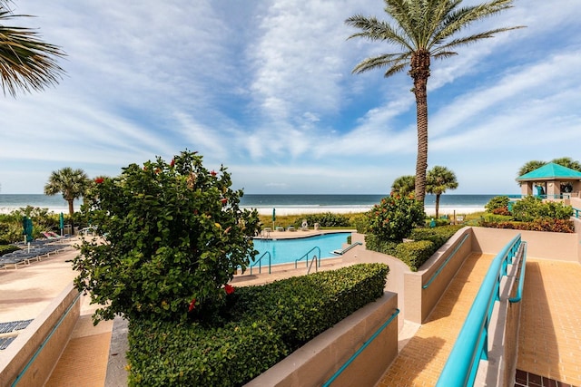 view of swimming pool featuring a water view