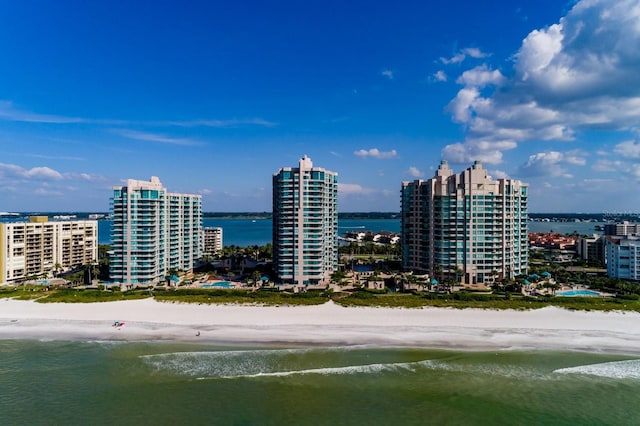 aerial view with a water view, a beach view, and a city view