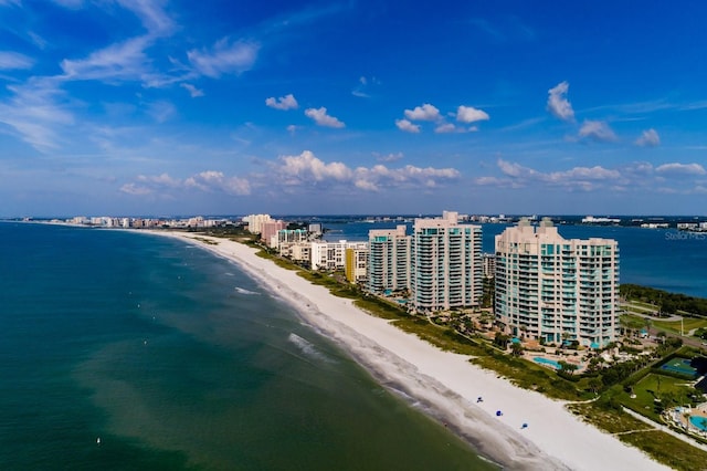 birds eye view of property featuring a view of the beach, a water view, and a view of city