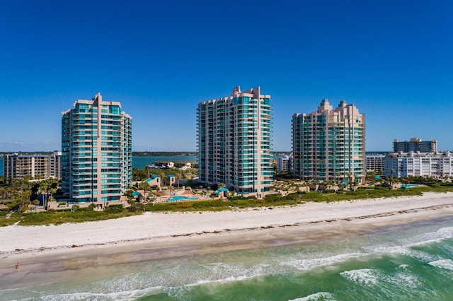 aerial view featuring a city view, a beach view, and a water view