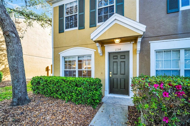 property entrance with stucco siding