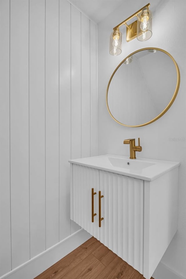 bathroom with a sink and wood finished floors