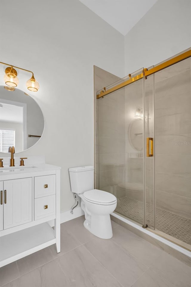 full bathroom featuring a stall shower, vanity, toilet, and tile patterned floors