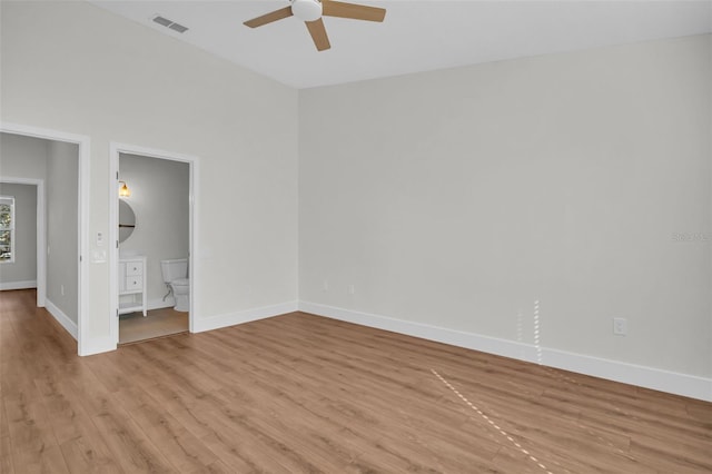 unfurnished room with light wood-style floors, ceiling fan, and baseboards