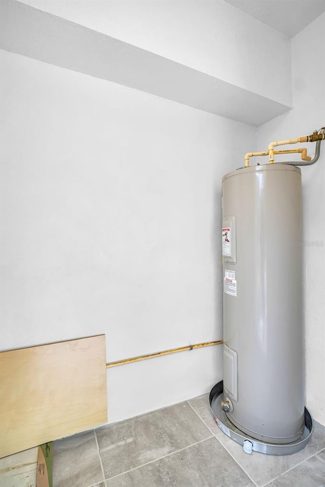 utility room featuring water heater