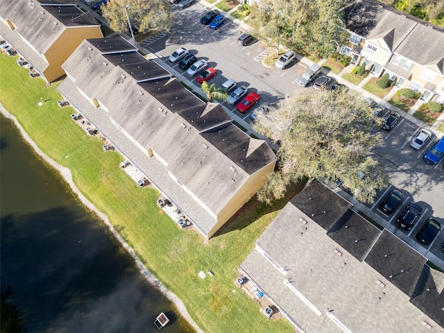 drone / aerial view with a water view and a residential view